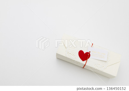 White gift box with hearts on a white background 136450152