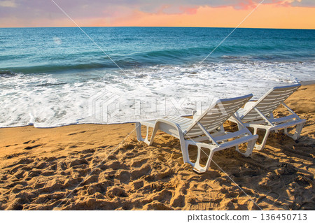 Pair of Beach chairs next to calm water of   Sea or Ocean 136450713