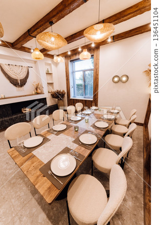 Boho private dining room set for dinner with rattan lamps and pampas wall 136451104