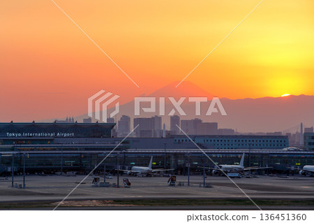 Haneda Airport terminal with a view of the sunset and Mt. Fuji 136451360