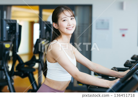 Young woman training in a sports gym Young woman training in a sports gym 136451718