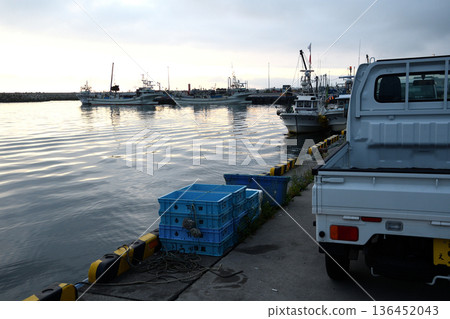 Light trucks working at the fishing port 136452043