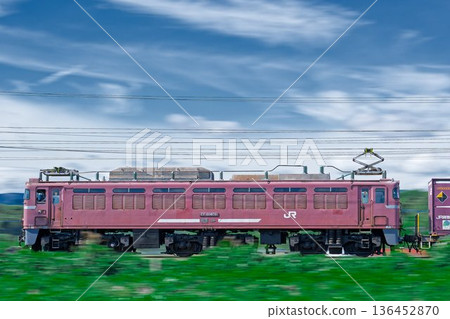 A freight train hauled by an EF81 electric locomotive runs smoothly on the JR Kagoshima Main Line. A freight train hauled by an EF81 electric locomotive runs smoothly on the JR Kagoshima Main Line. 136452870