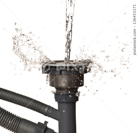 Pouring Leaking water from gray plastic pipe drain sink. Drain sink leak water from pipe plumbing in bathroom as water splash clogged drop. White background isolated 136453171