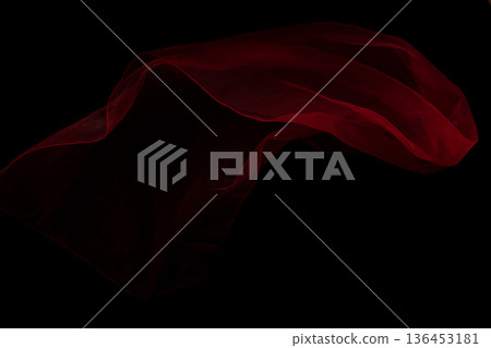 Red organza fabric flying in curve shape, Piece of textile Red organza fabric throw fall in air. Black background isolated, dark shading environment Red organza fabric flying in curve shape, Piece of textile Red organza fabric throw fall in air. Black background isolated, dark shading environment 136453181