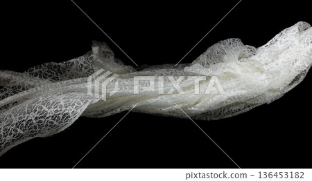 White lace fabric flying in curve shape, Piece of textile white lace fabric throw fall in air. Black background isolated, dark shading environment White lace fabric flying in curve shape, Piece of textile white lace fabric throw fall in air. Black background isolated, dark shading environment 136453182