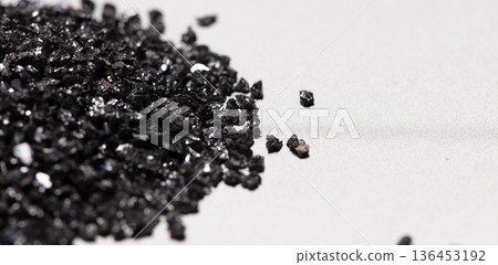 Pile of Silicon Carbide. Black Silicon Carbide crash in small pieces as material based. Fine particle circle around, White background Isolated showing particle element object 136453192