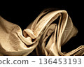 Yellow gold curtain fabric flying in curve shape, Piece of textile yellow gold curtain fabric throw fall in air. Black background isolated, dark shading environment 136453193