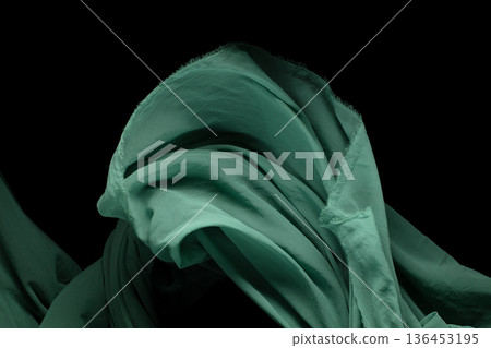Green Organza fabric flying in curve shape, Piece of textile Green Organza fabric throw fall in air. Black background isolated, dark shading environment Green Organza fabric flying in curve shape, Piece of textile Green Organza fabric throw fall in air. Black background isolated, dark shading environment 136453195