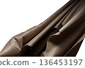 Brown gold canvas fabric flying in curve shape, Piece of textile Brown gold canvas fabric throw fall in air. White background isolated, dark shading environment 136453197