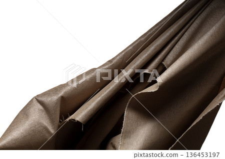 Brown gold canvas fabric flying in curve shape, Piece of textile Brown gold canvas fabric throw fall in air. White background isolated, dark shading environment Brown gold canvas fabric flying in curve shape, Piece of textile Brown gold canvas fabric throw fall in air. White background isolated, dark shading environment 136453197