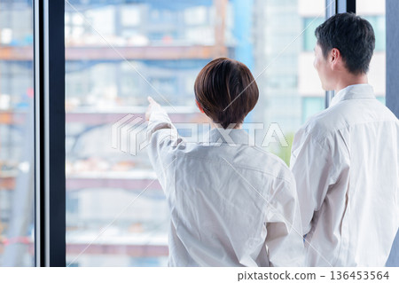 Workers looking at the construction site Workers looking at the construction site 136453564