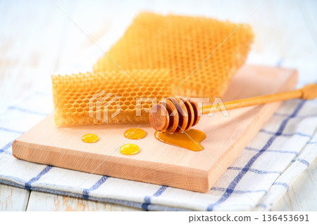 sweet honey with honeycomb on a white table. 136453691