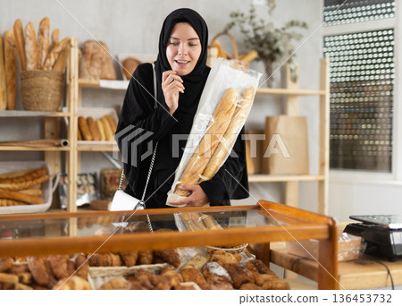 Muslim woman in a bakery chooses pastries 136453732