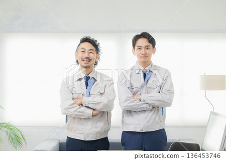 A man in work clothes making a guts pose 136453746