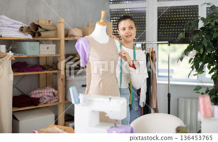 Asian woman working with mannequin in workshop 136453765