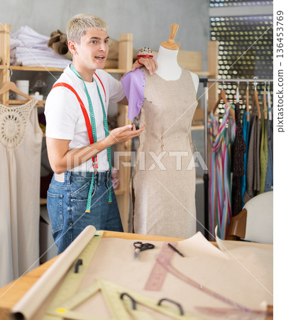 Young male tailor working with mannequin Young male tailor working with mannequin 136453769