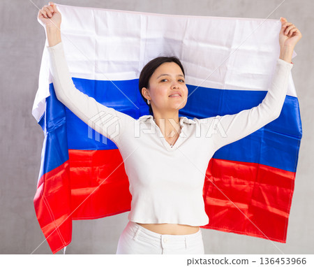 Young woman posing in studio with flag of Russia Young woman posing in studio with flag of Russia 136453966
