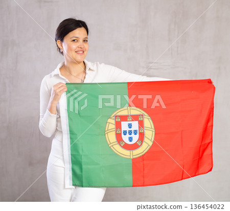 Young woman posing in studio with Portugal flag Young woman posing in studio with Portugal flag 136454022