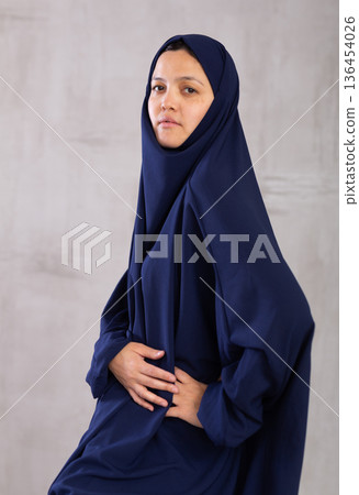 Portrait of young serious woman in hijab posing in studio Portrait of young serious woman in hijab posing in studio 136454026
