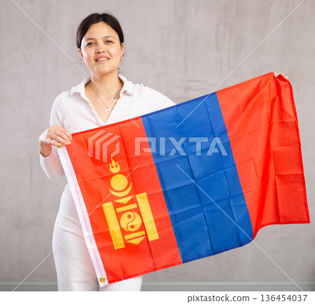 Female fan of team of the country of Mongolia with national flag in her hands Female fan of team of the country of Mongolia with national flag in her hands 136454037
