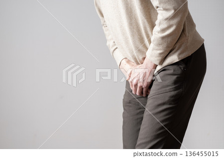 Middle-aged man with frequent urination, urinary urge, urinary incontinence, body parts 136455015
