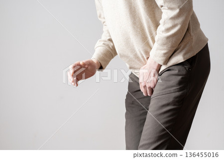 Middle-aged man with frequent urination, urinary urge, urinary incontinence, body parts 136455016