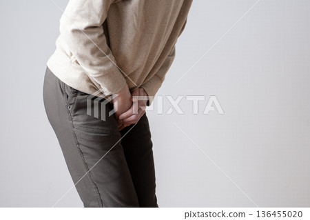 Middle-aged man with frequent urination, urinary urge, urinary incontinence, body parts 136455020