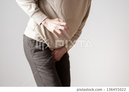 Middle-aged man with frequent urination, urinary urge, urinary incontinence, body parts 136455022
