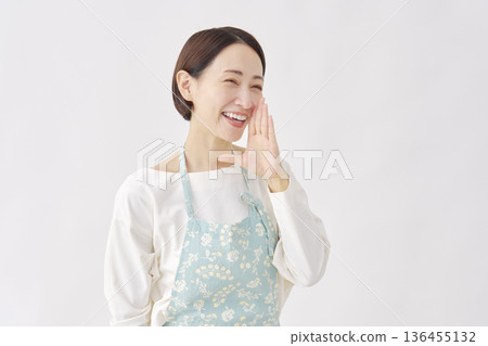 Woman wearing an apron cheering white background facing right Woman wearing an apron cheering white background facing right 136455132