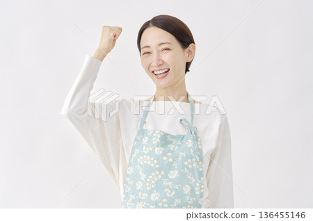 Woman wearing an apron, fist pump, white background Woman wearing an apron, fist pump, white background 136455146