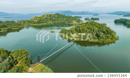 Kaeng Krachan dam with lake view and many green moutain, blue sky background. Kaeng Krachan Dam national park, Phetchaburi province, Thailand in aerial view from drone. Kaeng Krachan dam with lake view and many green moutain, blue sky background. Kaeng Krachan Dam national park, Phetchaburi province, Thailand in aerial view from drone. 136455164