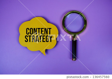 Content Strategy text on speech bubble with magnifying glass on purple background 136457560