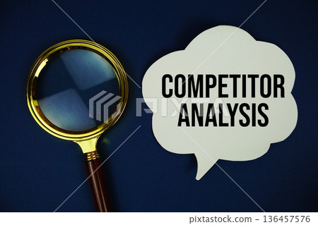 Competitor Analysis text on speech bubble with magnifying glass on navy blue background Competitor Analysis text on speech bubble with magnifying glass on navy blue background 136457576