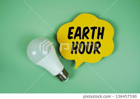 Earth Hour with light bulb on green background 136457590