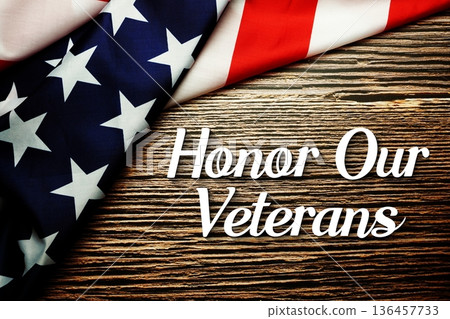 Honor Our Veterans text with American USA Flag on wooden background 136457733