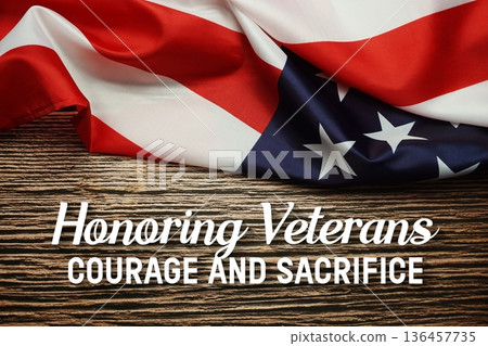 Honoring Veterans Courage and Sacrifice text with American USA Flag on wooden background 136457735