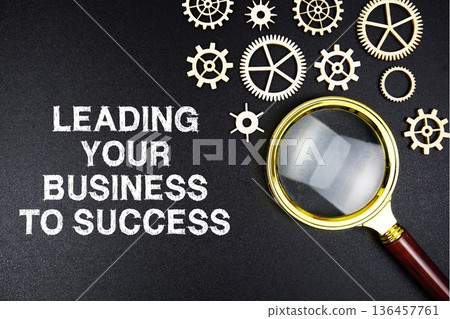 Leading Your Business To Success text message with magnifying glass on black background 136457761