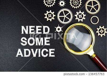 Need Some Advice text message with magnifying glass on black background 136457763