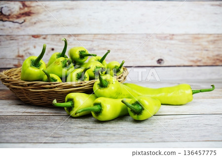 Fresh raw green bell pepper in bamboo basket on wooden background 136457775
