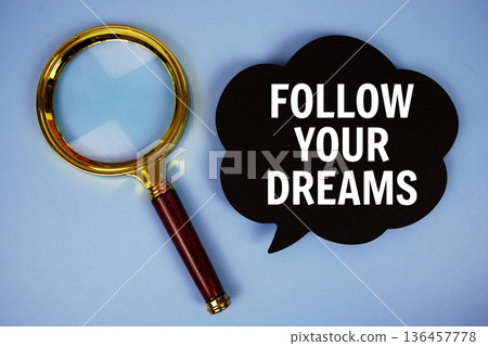 Follow Your Dreams text on speech bubble with magnifying glass on blue background Follow Your Dreams text on speech bubble with magnifying glass on blue background 136457778