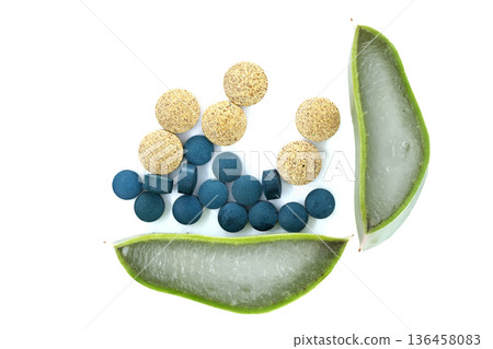 Natural health supplements including spirulina tablets and aloe vera slices on white background Natural health supplements including spirulina tablets and aloe vera slices on white background 136458083