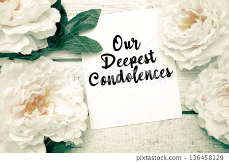 Our Deepest Condolences text with flowers bouquet on wooden background Our Deepest Condolences text with flowers bouquet on wooden background 136458129