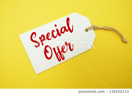 Price tag with "Special Offer" is placed on yellow background 136458133