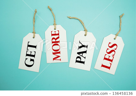 Price tag with "Get More Pay Less" is placed on blue background Price tag with "Get More Pay Less" is placed on blue background 136458136