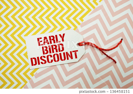 Price tag with "Early Bird Discount" is placed on a colorful zigzag patterned background Price tag with "Early Bird Discount" is placed on a colorful zigzag patterned background 136458151