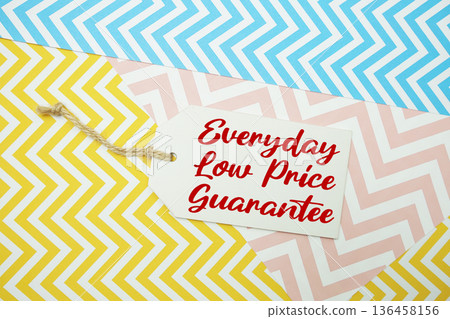 Price tag with "Everyday Low Price Guarantee" is placed on a colorful zigzag patterned background, symbolizing a limited-time promotional offer Price tag with "Everyday Low Price Guarantee" is placed on a colorful zigzag patterned background, symbolizing a limited-time promotional offer 136458156