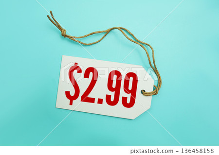 Price tag with "$2.99" is placed on blue background 136458158