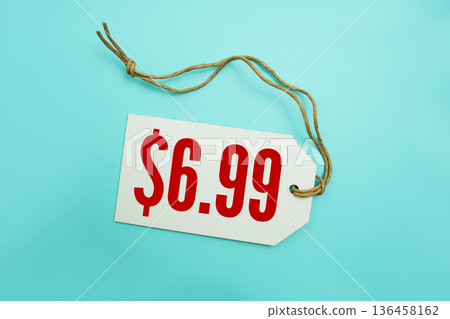 Price tag with "$6.99" is placed on blue background Price tag with "$6.99" is placed on blue background 136458162
