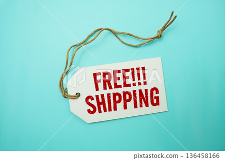 Price tag with "Free Shipping" is placed on blue background 136458166